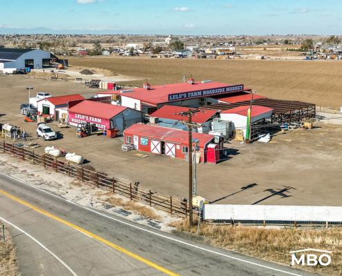 a photo of Lulus Roadside Market with red roofs and white buildings on a hills side