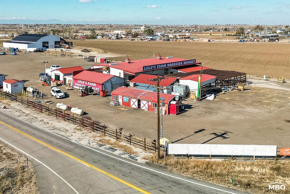 Lulus Farm Roadside Market a photo of Lulus Roadside Market with red roofs and white buildings on a hills side