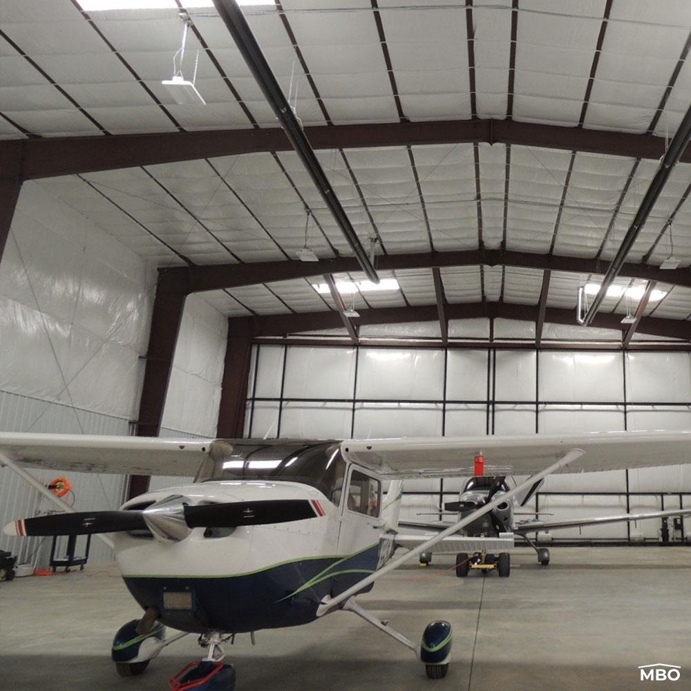 aircraft stored in an insulated rigid framed hangar