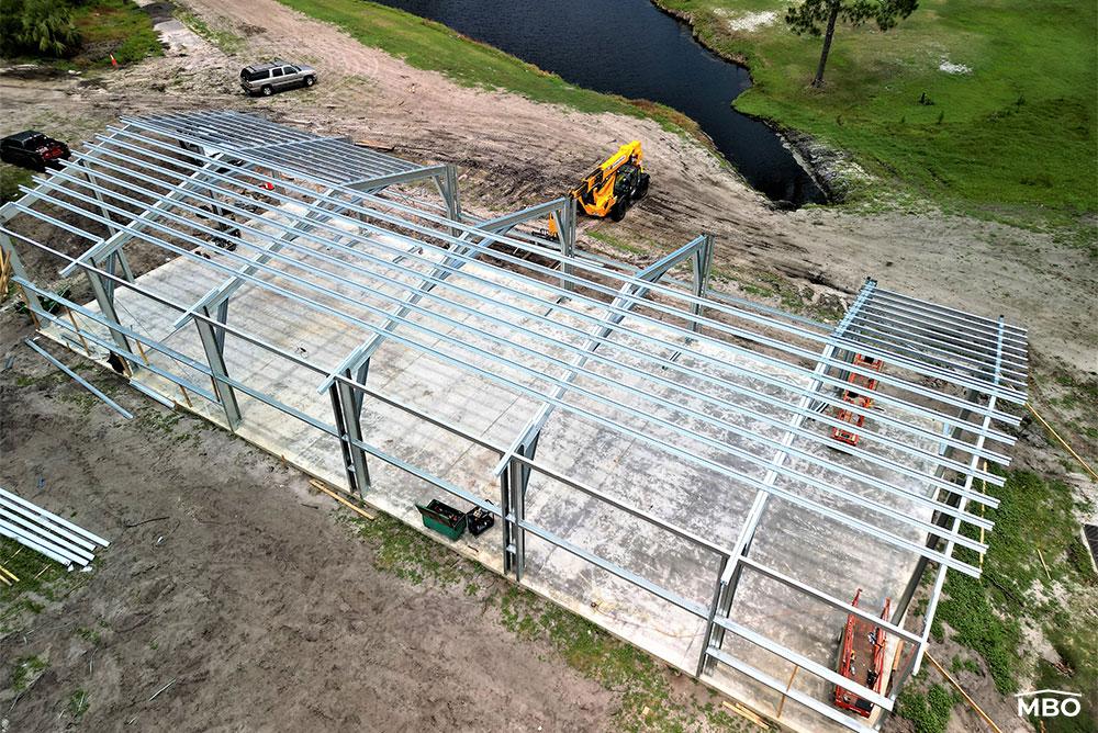 cold formed building in Florida and a lake in the back ground while the building is being erected