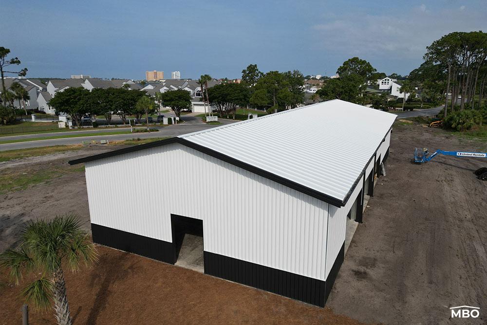 a finished cold formed building in Floring with white wall panels and black trim