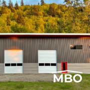 a unique cold formed metal building with two tone grey siding arranged in a pattern