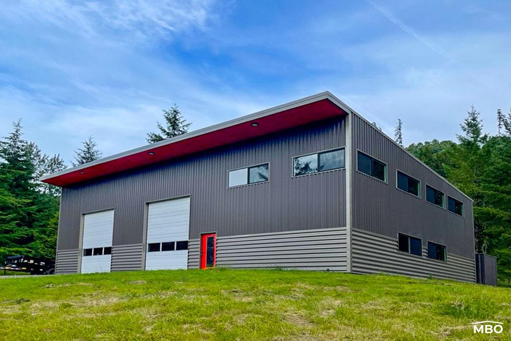 cold-formed-wa cold formed metal building that is two tone grey with dual roll up doors and living area