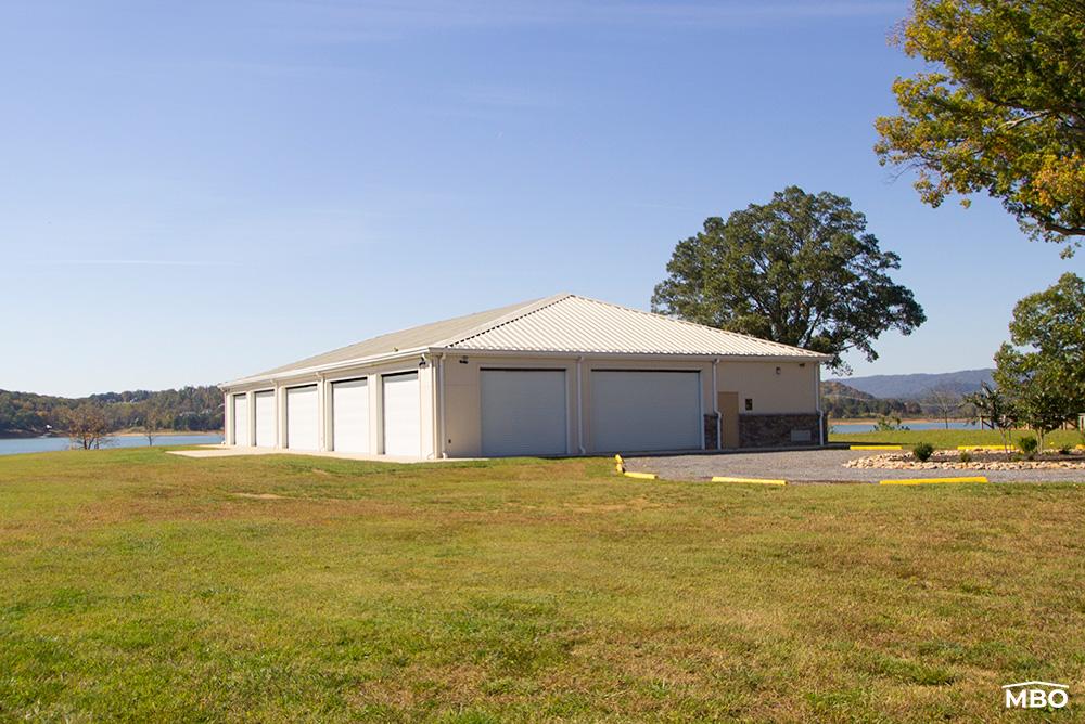 hip-roof exterior of the church with brick wainscot