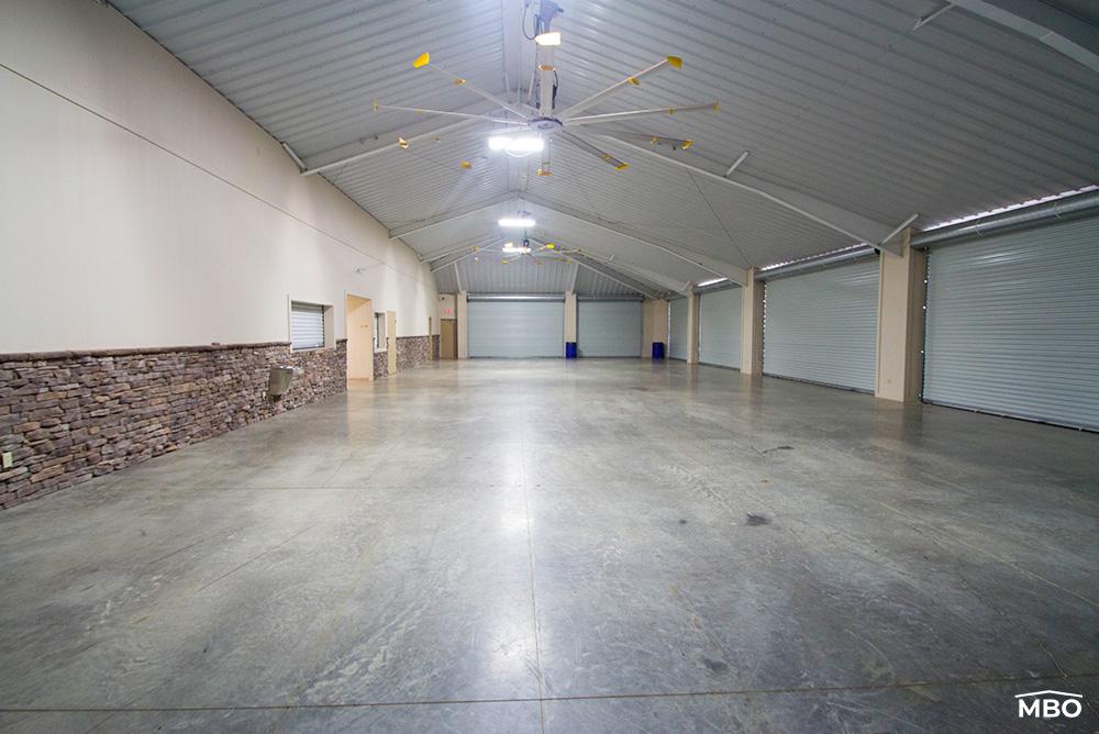 metal-building-hip-roof interior of the church that is intended to be open air when the roll doors are up