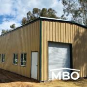 Tan Metal Building with a Garage Door