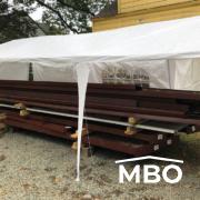 Red Iron Beams under a White Tent